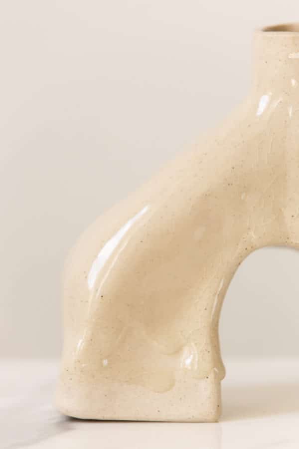 Large hand-built beige ceramic vase this is uniquely curved and a detail image